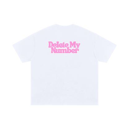 White graphic T-shirt with pink “Delete My Number” text printed across the back