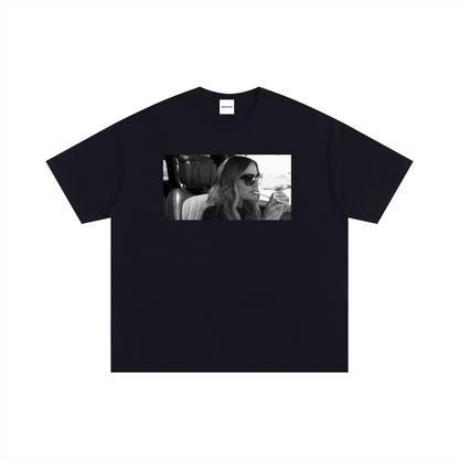 Black and white graphic T-shirt featuring Dorit Kemsley wearing sunglasses and lighting a cigarette inside a car, inspired by an iconic Beverly Hills reality TV moment.