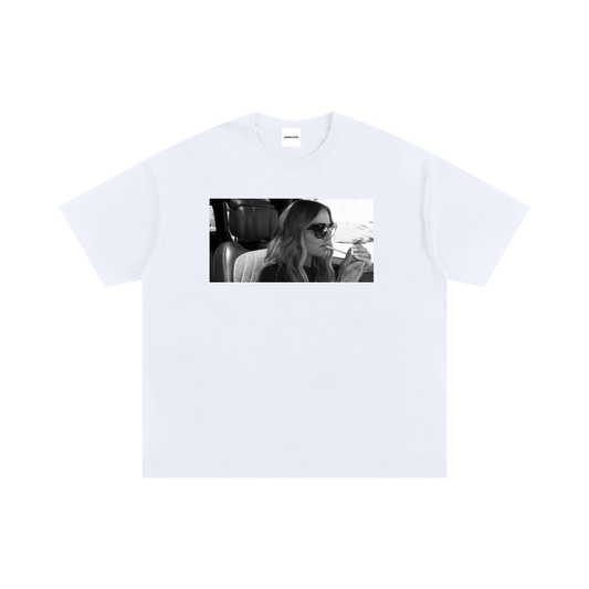 Black and white graphic T-shirt featuring Dorit Kemsley wearing sunglasses and lighting a cigarette inside a car, inspired by an iconic Beverly Hills reality TV moment.